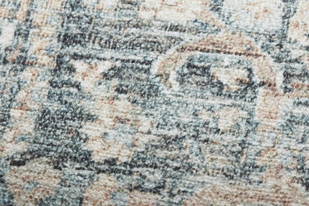 Close-up of the Humboldt pillow highlighting the woven texture, ocean blue and clay tones, knife-edge finish, and hidden zipper with antique bronze Loloi logo pull.