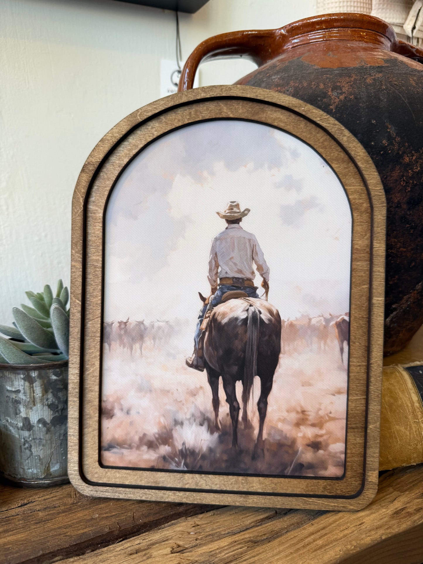 Arch Top Cattle Drive Framed Canvas Art featuring a classic Western cattle drive scene in a handcrafted arched wood frame with an Early American finish.