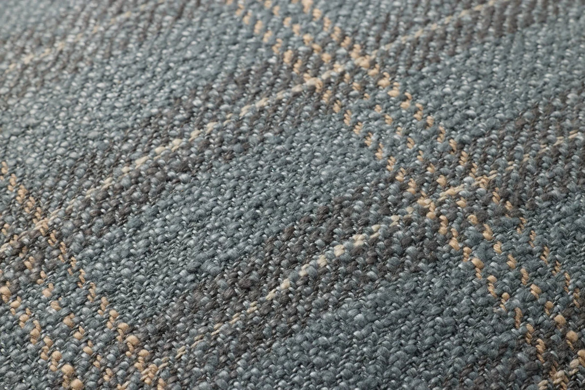 Close-up of the Stockton Blue pillow showcasing the woven plaid texture, hidden zipper with antique bronze Loloi logo pull, and tailored craftsmanship.