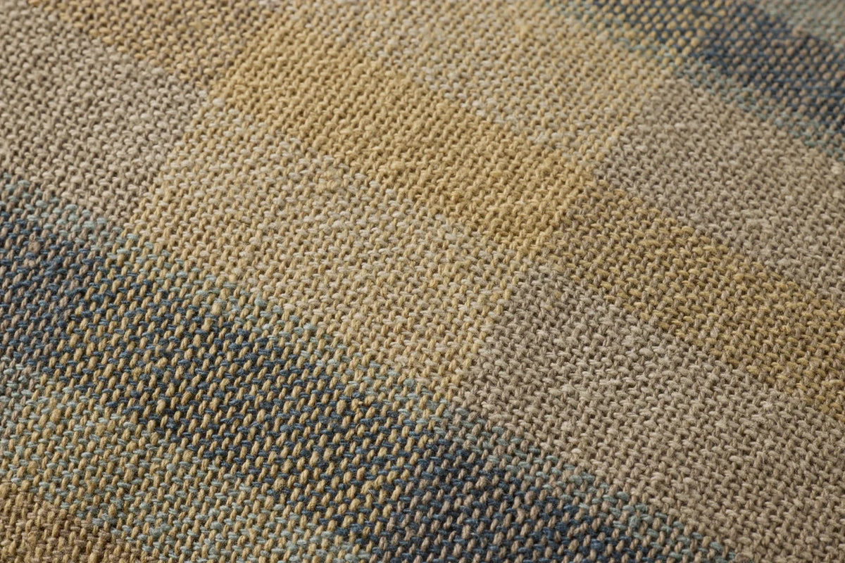 Close-up of the Andi pillow highlighting the woven cotton and rayon texture, hidden zipper, and antique bronze Loloi logo pull.