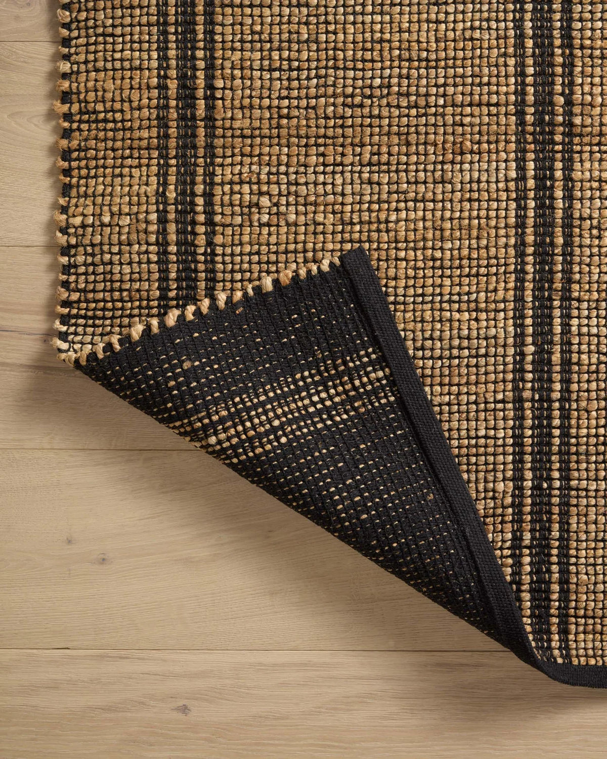 Close-up of the Colton rug showcasing the woven jute and cotton texture, natural fibers, and artisan craftsmanship.