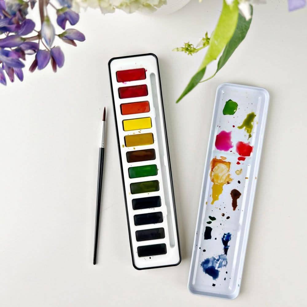 Travel watercolor paint palette featuring richly pigmented artist colors.