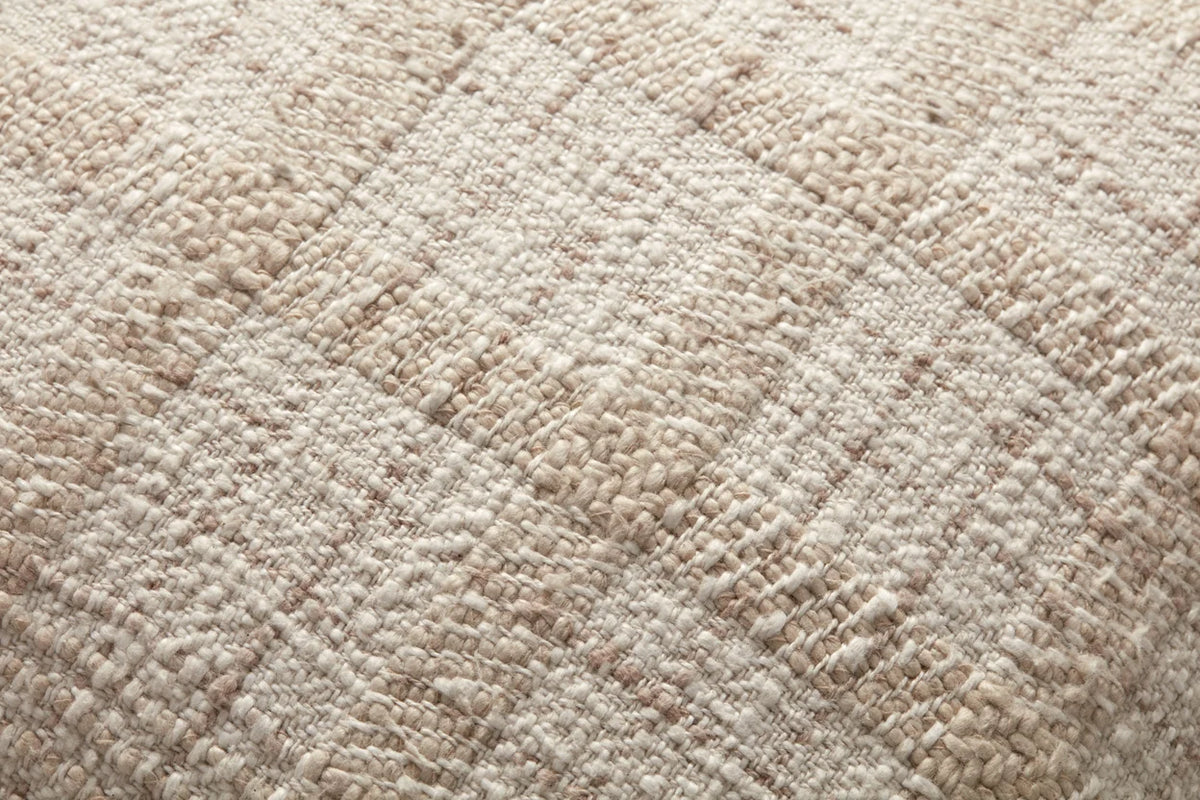 Close-up of the Fern pillow highlighting the woven check texture, knife-edge finish, and hidden zipper with antique bronze Loloi logo pull.