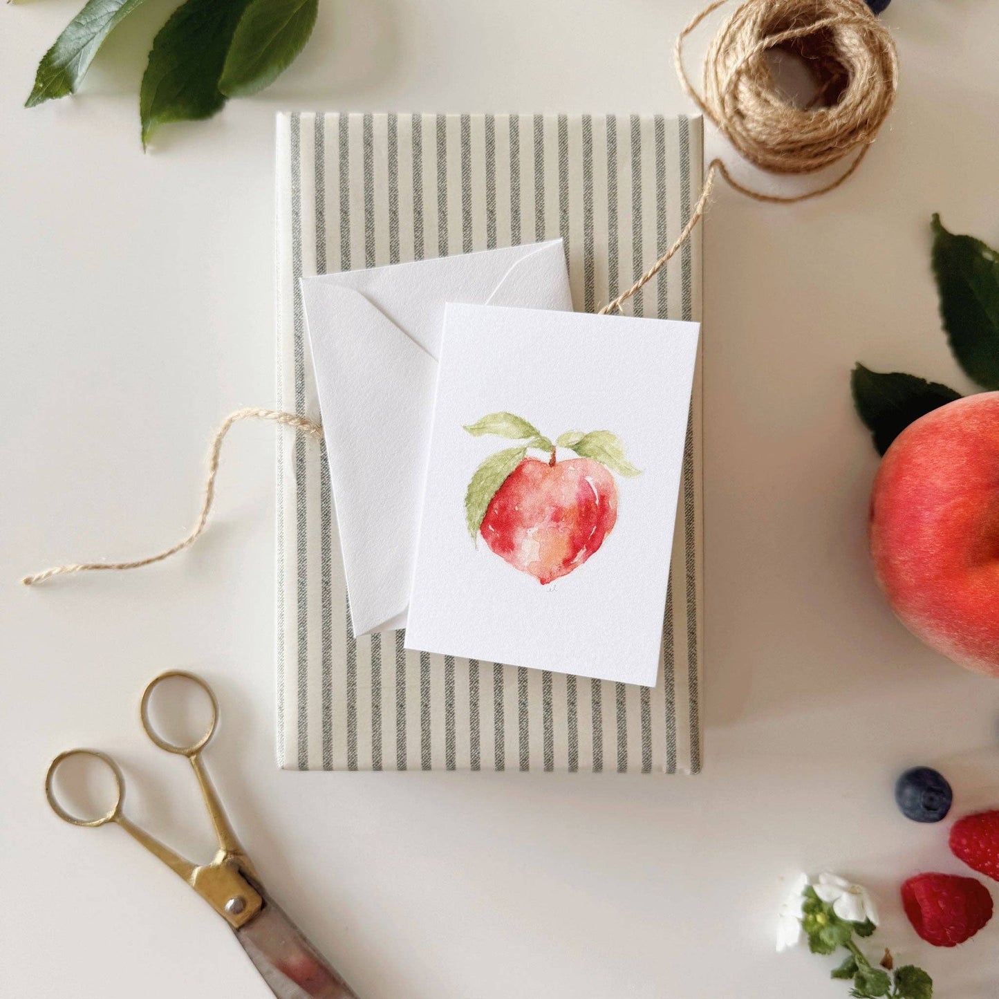 Fruit-inspired mini enclosure card attached to a wrapped gift.