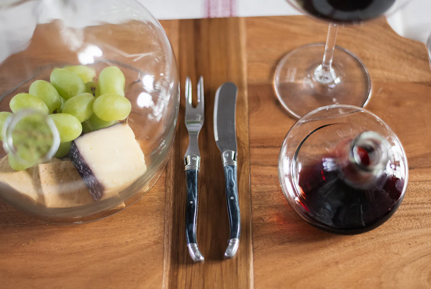 French Laguiole cheese fork with marbled grey handle styled on an artisan charcuterie board for gathered entertaining