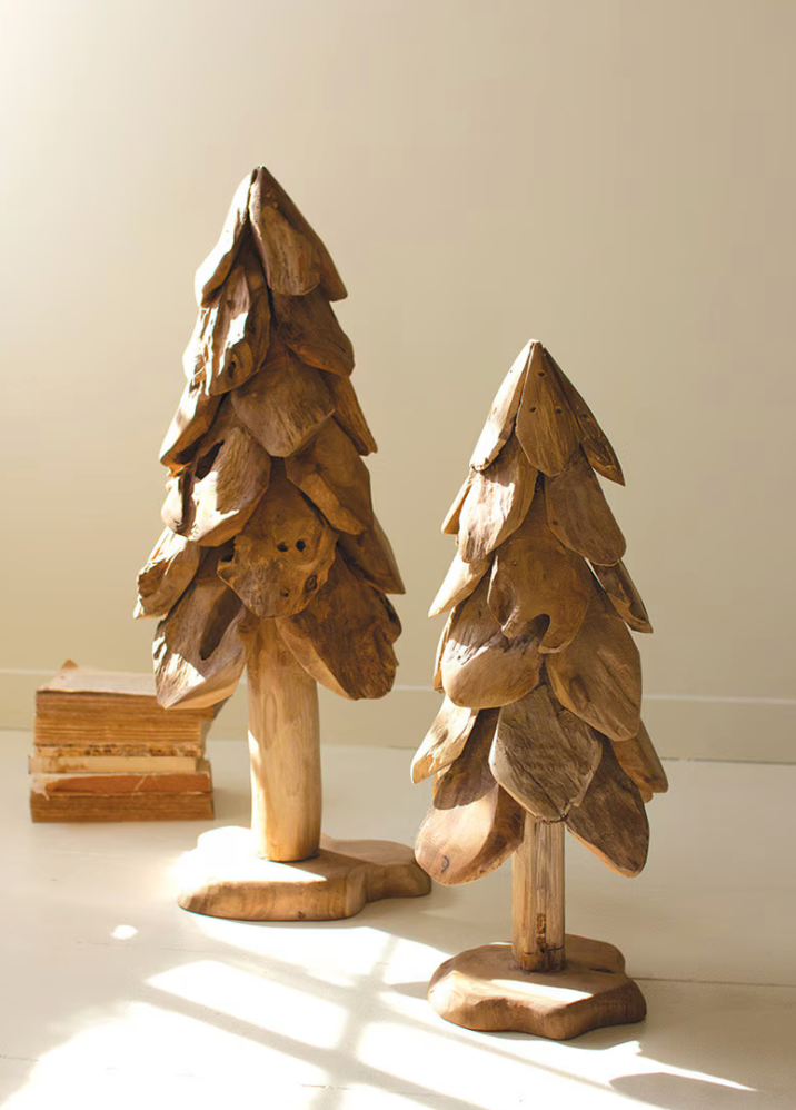 Large handcrafted teak Christmas tree adding warmth and natural texture to an organic modern holiday home.