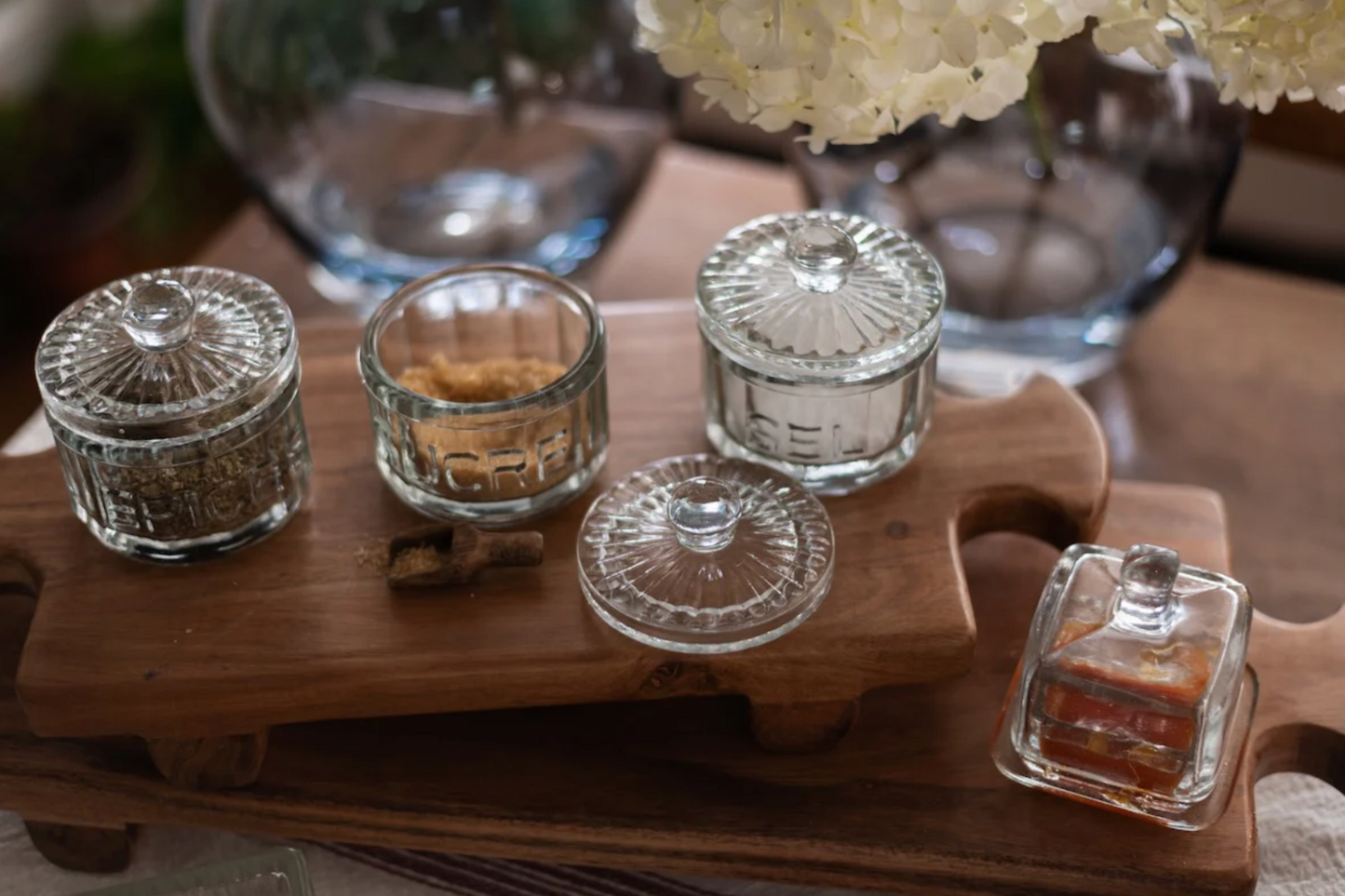 Large Normandy wood riser footed tray crafted from acacia wood styled on a warm modern ranch kitchen island