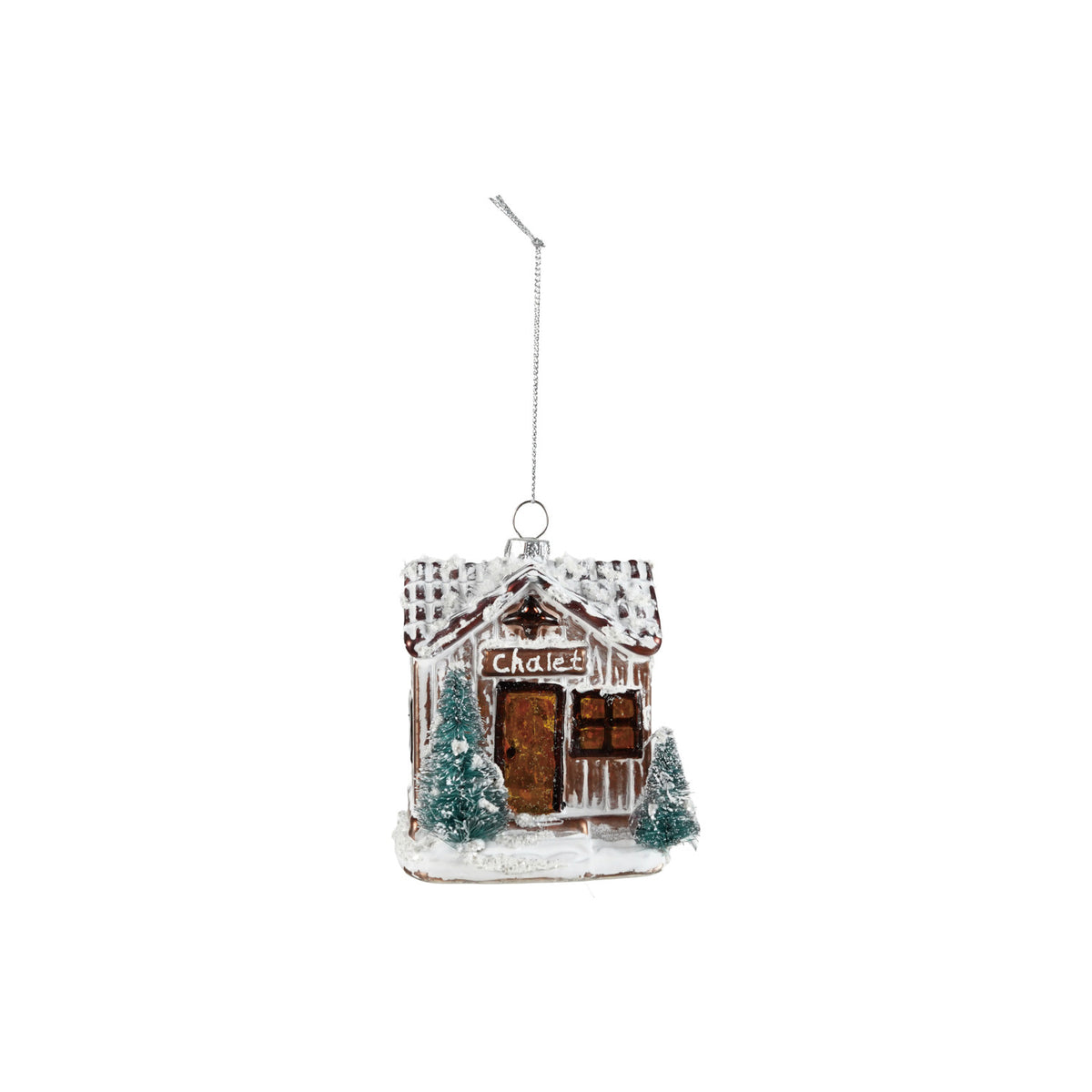 Lighted glass chalet house Christmas ornament with a snowy white roof, miniature evergreen trees, and warm LED glow.