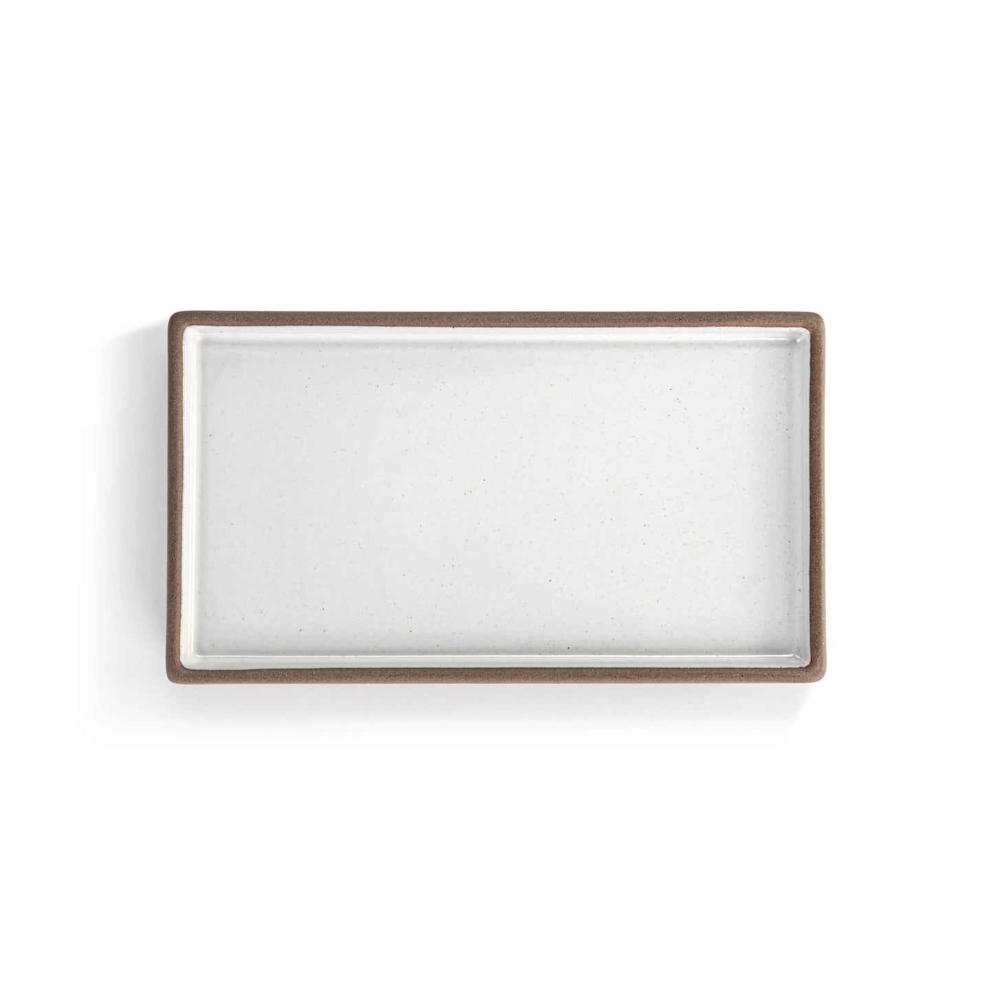 Small ceramic tray with a white and natural finish for decorative organization.