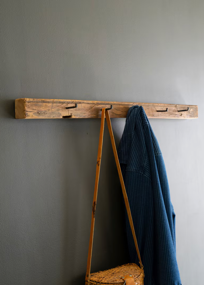 Rustic reclaimed wood featuring hand-forged iron hooks with natural wood grain.
