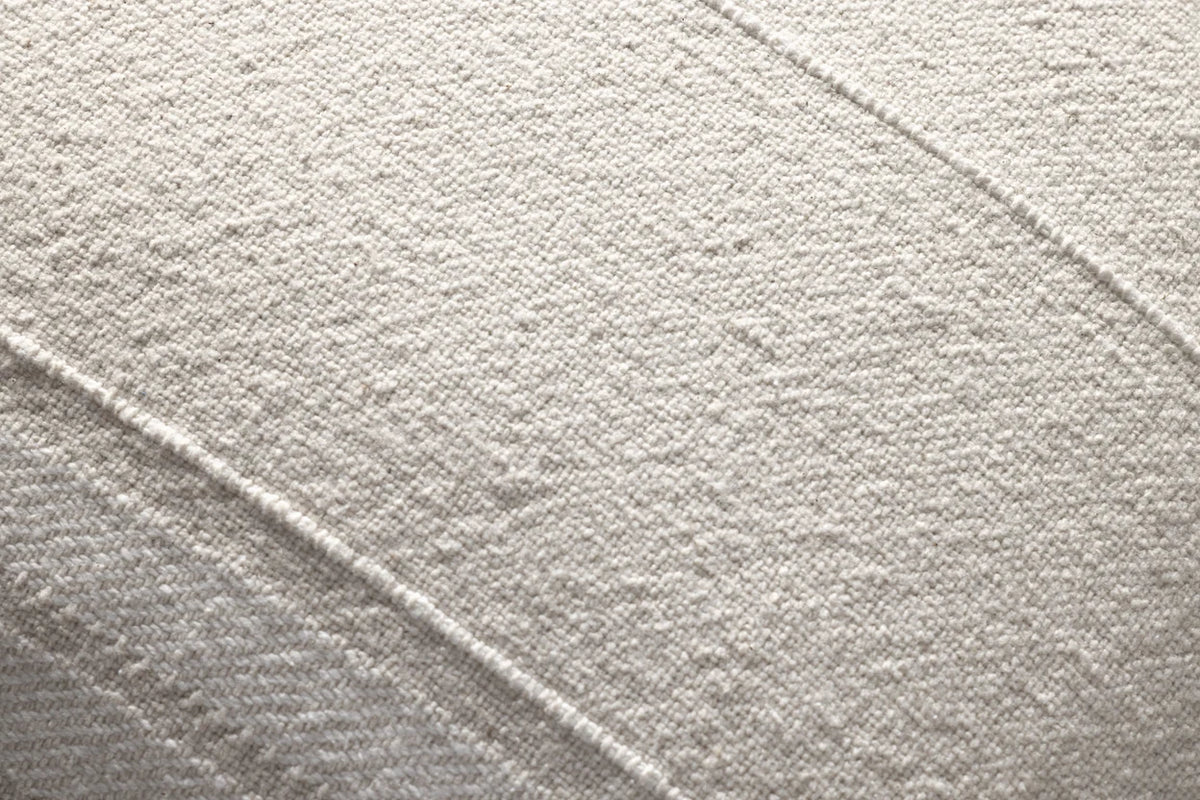 Close-up of the Selena pillow showcasing the woven cotton texture, knife-edge finish, and hidden zipper with antique bronze Magnolia Home logo pull.