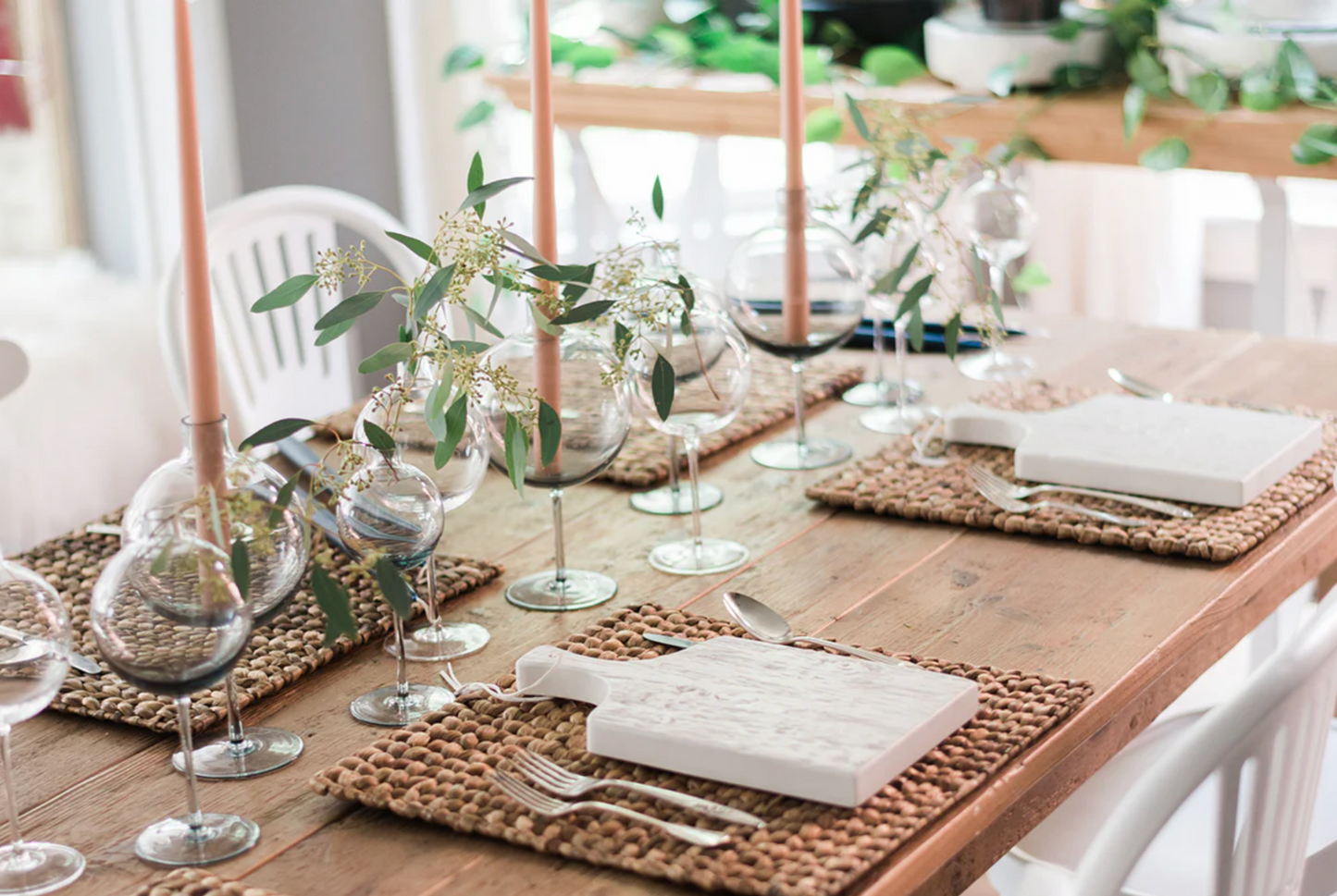 Clear wine glass vase with sculptural stem silhouette styled as a romantic dining table centerpiece