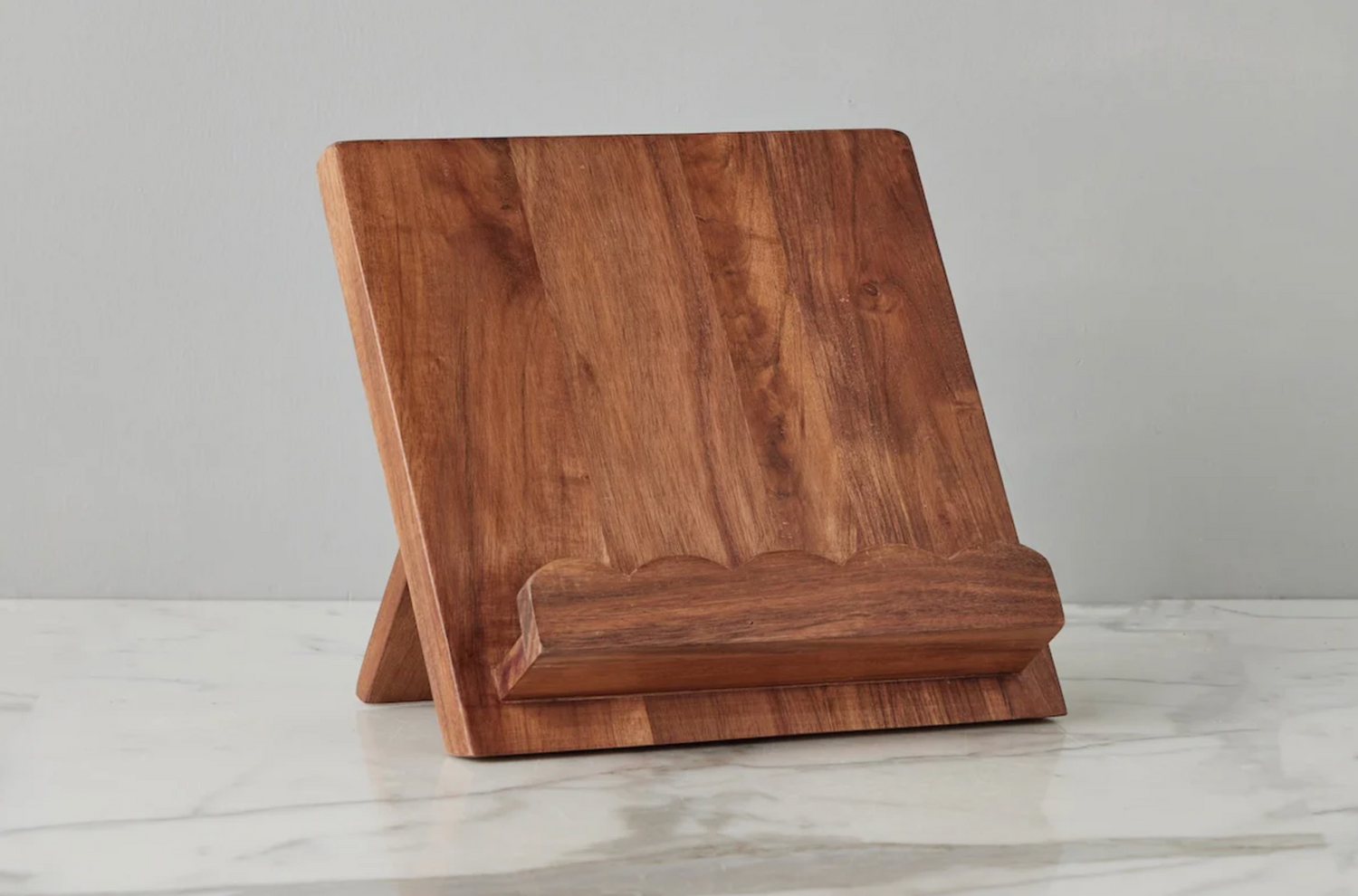 Wooden tablet stand on a light gray surface