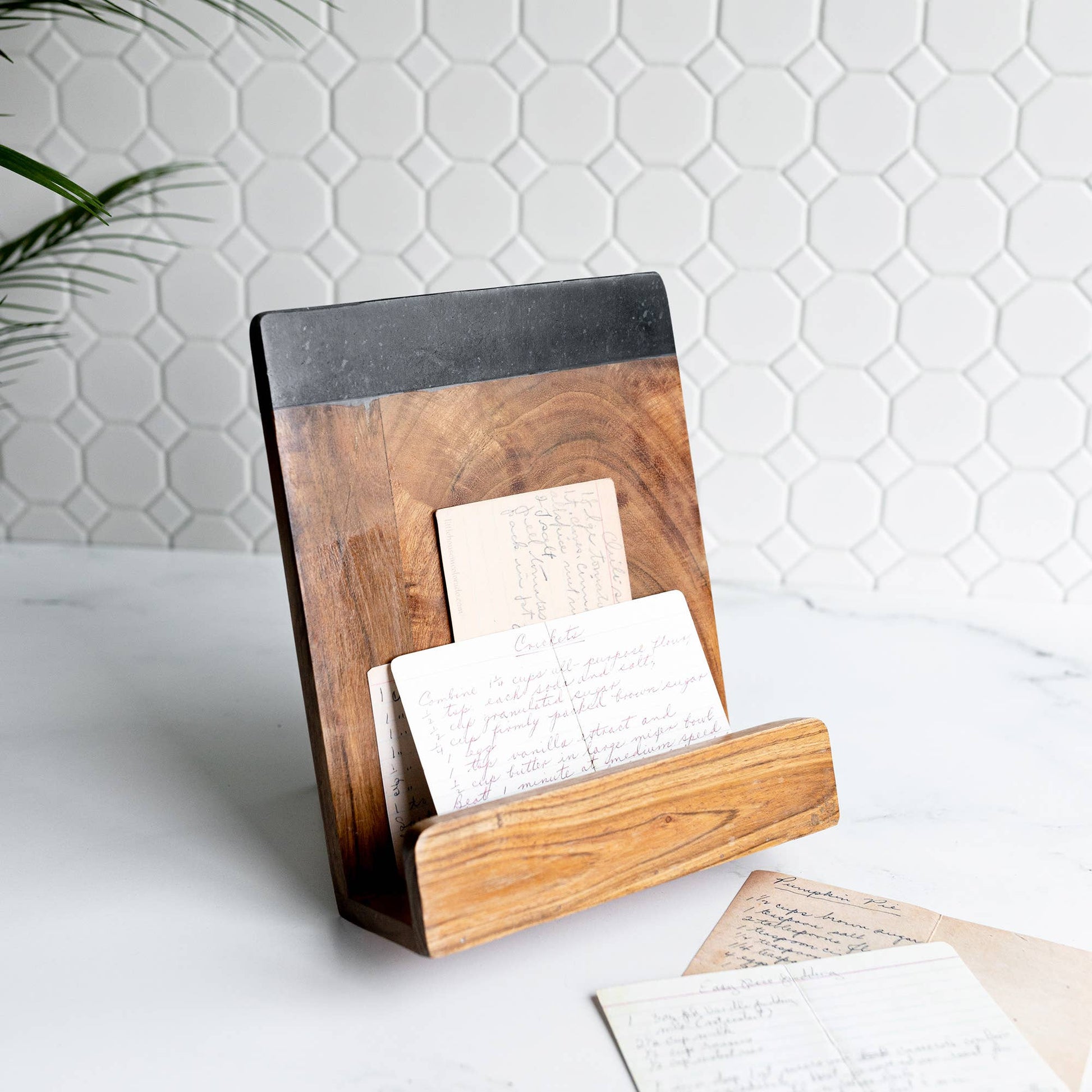 Acacia Wood & Marble Cookbook Holder crafted from natural acacia wood, solid black marble, and metal with a foldable design for displaying cookbooks or tablets.