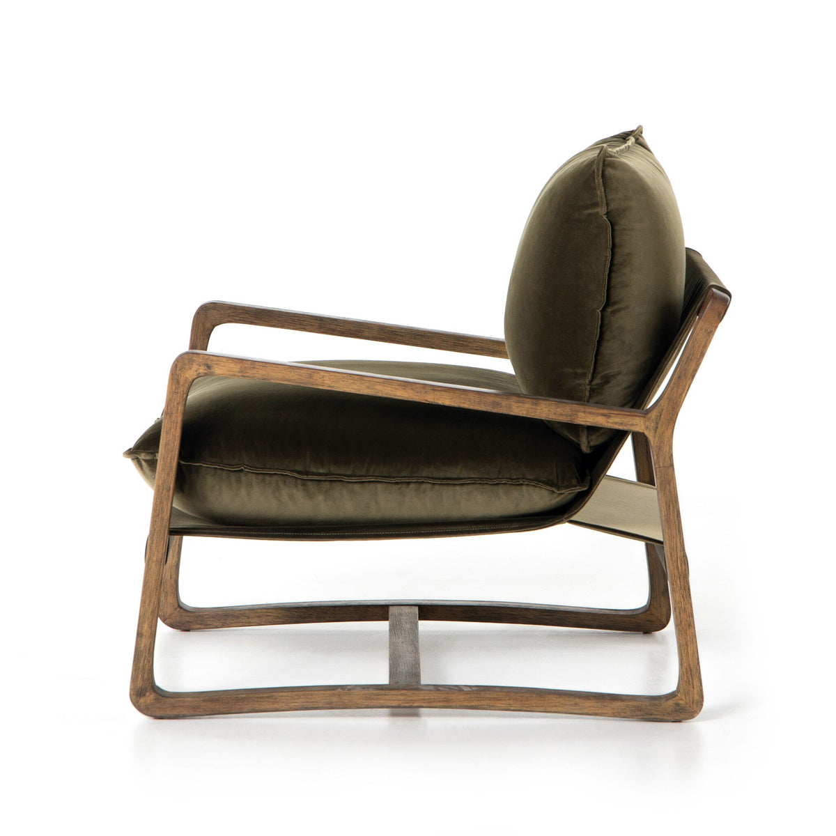 Side view of the Ace Olive Velvet Accent Chair showing its low seat and sculptural solid wood frame.