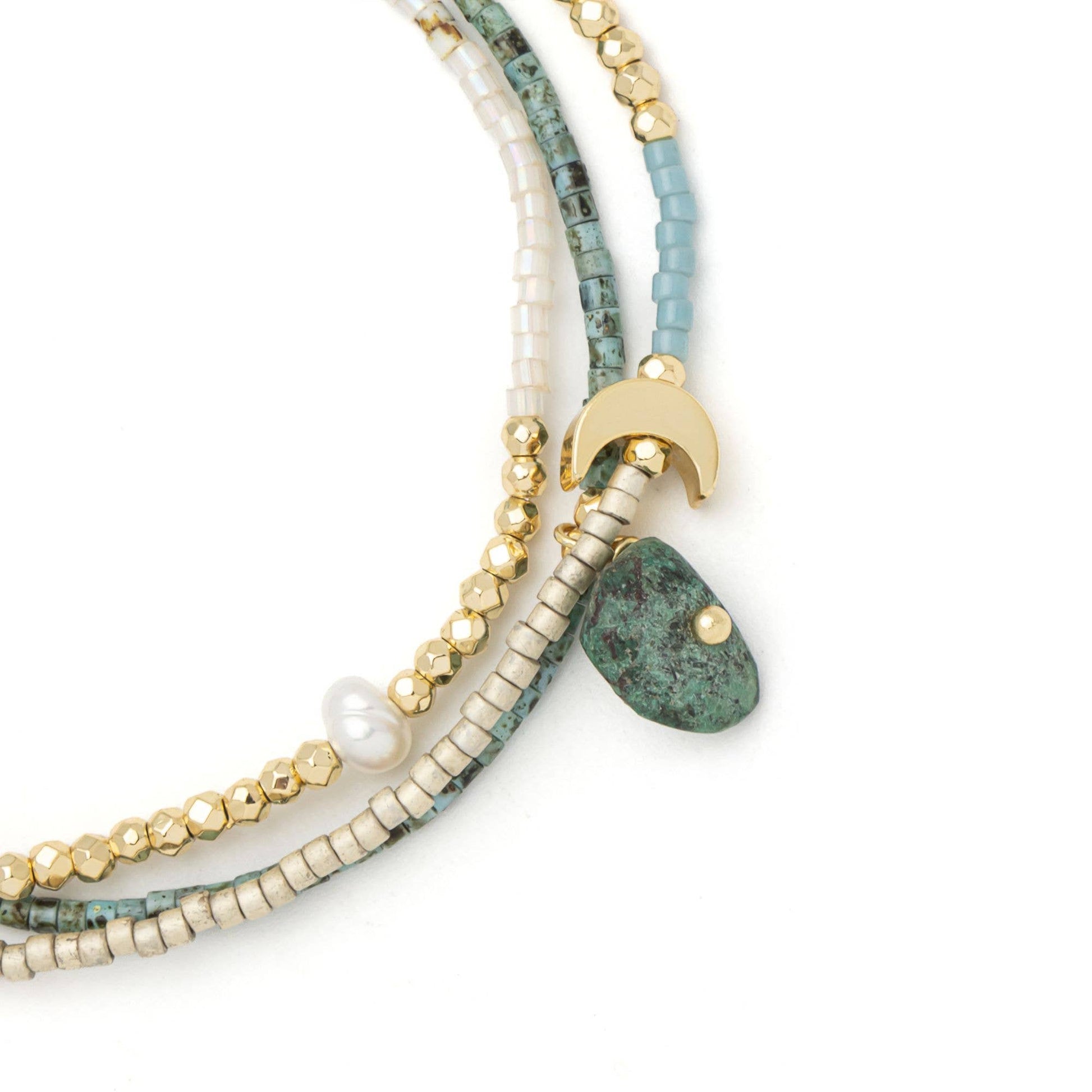 Close-up of handcrafted African Turquoise stones, freshwater pearls, Miyuki beads, and the adjustable pull-tie on the Mixed Media Wrap Bracelet & Necklace.