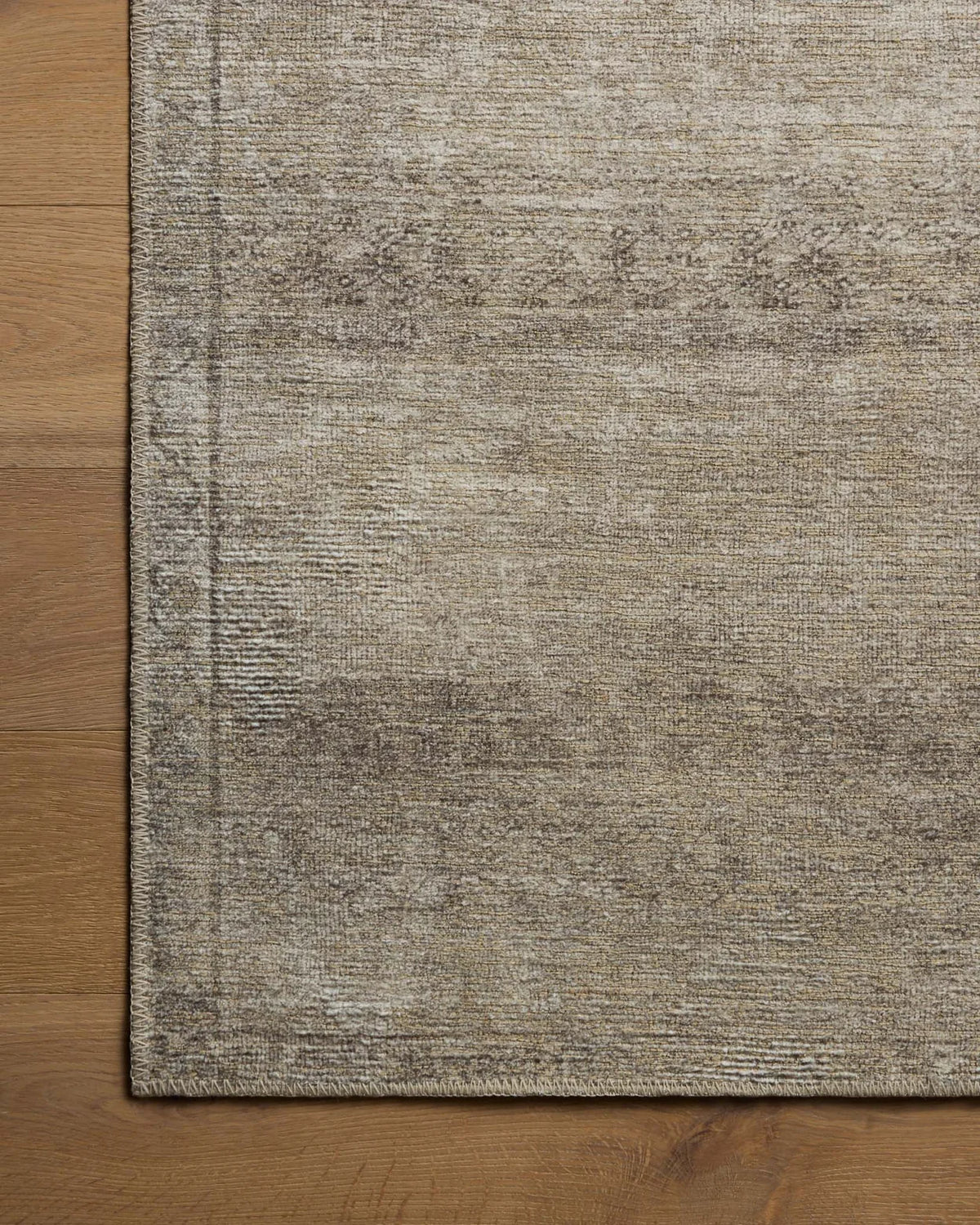Close-up of the Cambria rug highlighting the weathered vintage motif, woven jute texture, and low-profile construction.
