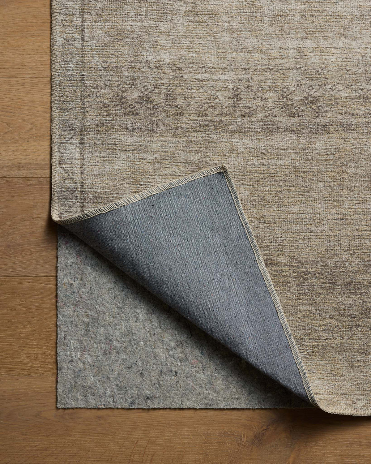 Close-up of the Cambria rug highlighting the weathered vintage motif, woven jute texture, and low-profile construction.