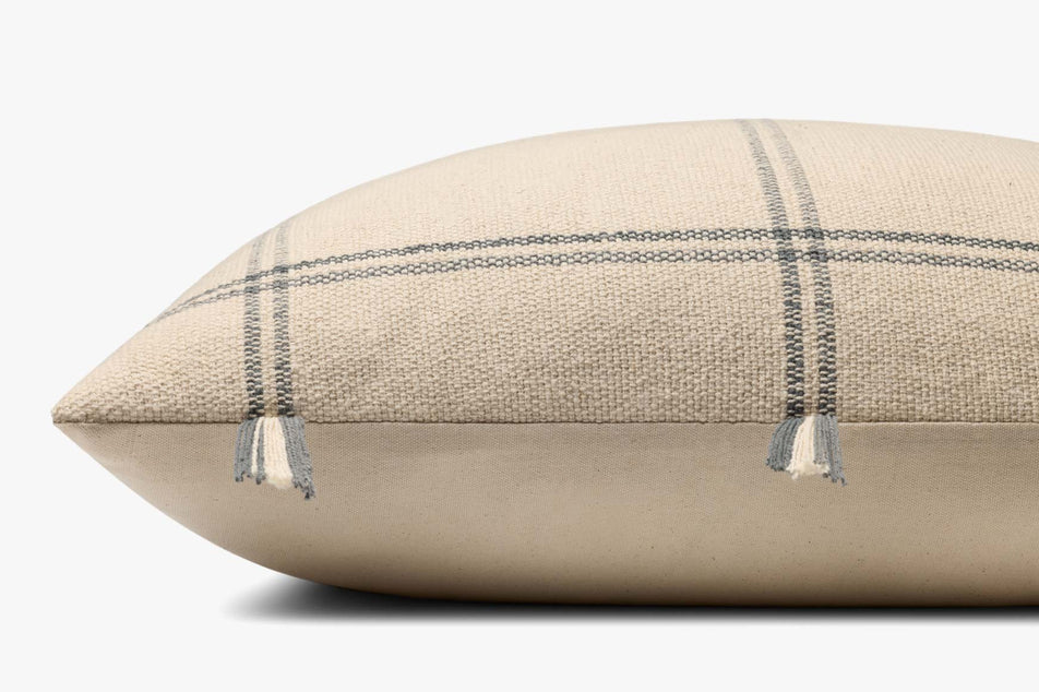 Close-up of the handwoven cotton texture and fringe edge on the Amber Lewis Lainey pillow.