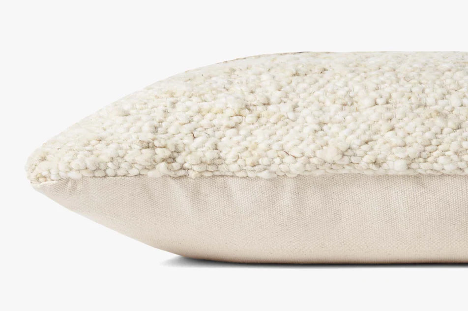 Amber Lewis × Loloi Marie handwoven throw pillow in ivory and camel, 22 x 22 inches.