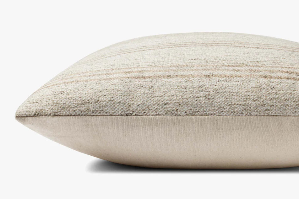 Close-up of the woven polyester and cotton texture on the Amber Lewis Zephyr pillow in ivory and natural.