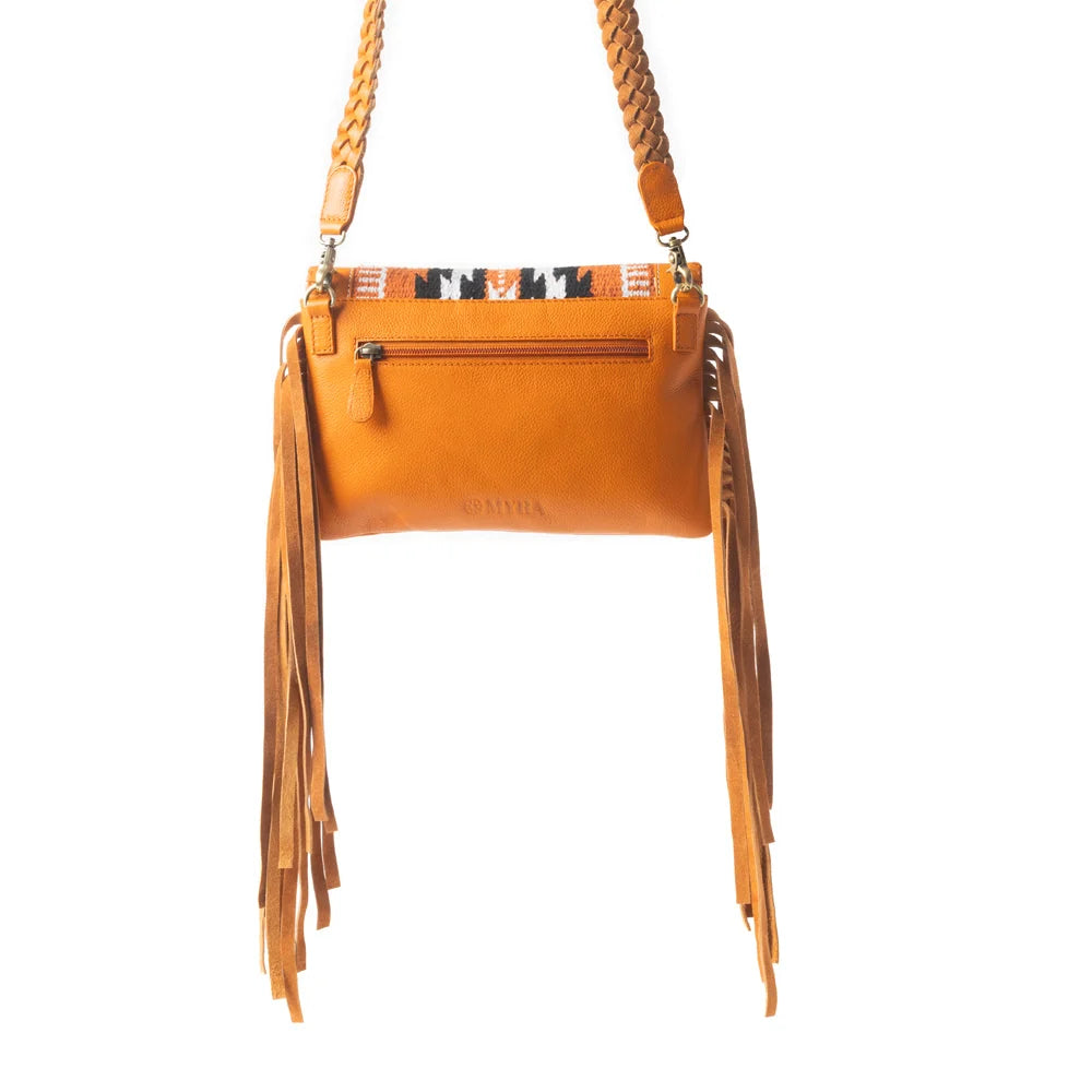 Close-up of the Mesa WingTrail bag showing warm leather, woven textile, decorative whipstitching, and fringe details.
