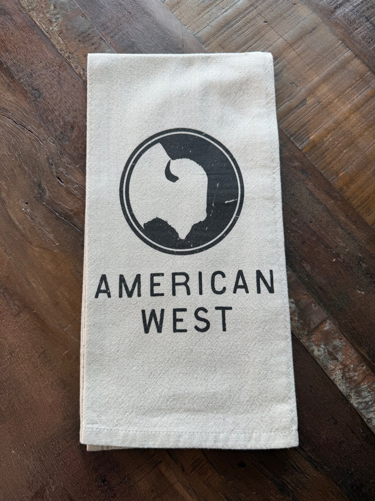 American West Logo Tea Towel featuring the American West logo on a natural cotton and linen blend kitchen towel.