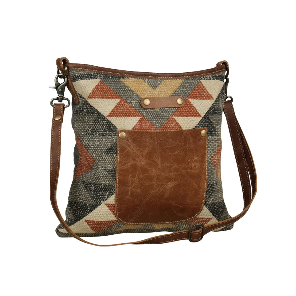 Angle Tangle shoulder bag crafted from patterned woven rug textile, canvas, and genuine leather.
