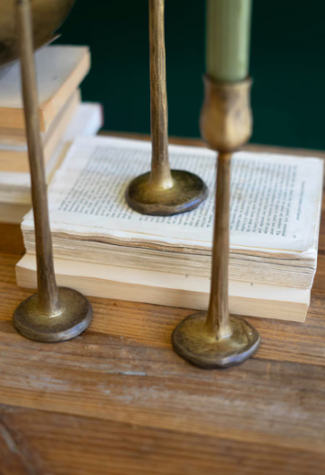 Antique brass candle holders adding warmth and layered sophistication to a thoughtfully curated home.