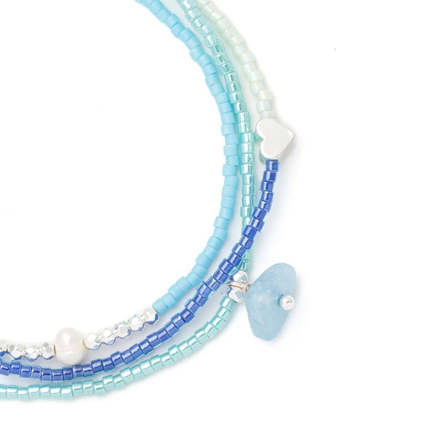 Close-up of handcrafted aquamarine stones, freshwater pearls, Miyuki beads, and adjustable pull-tie on the Mixed Media Wrap Bracelet & Necklace.