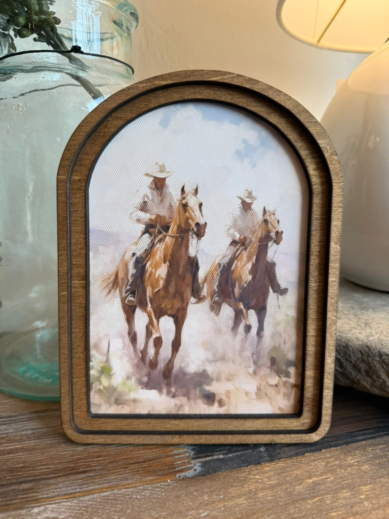 Arch Top Cowboys Framed Canvas Art featuring a timeless western cowboy scene in a handcrafted arched wood frame with an Early American stain.