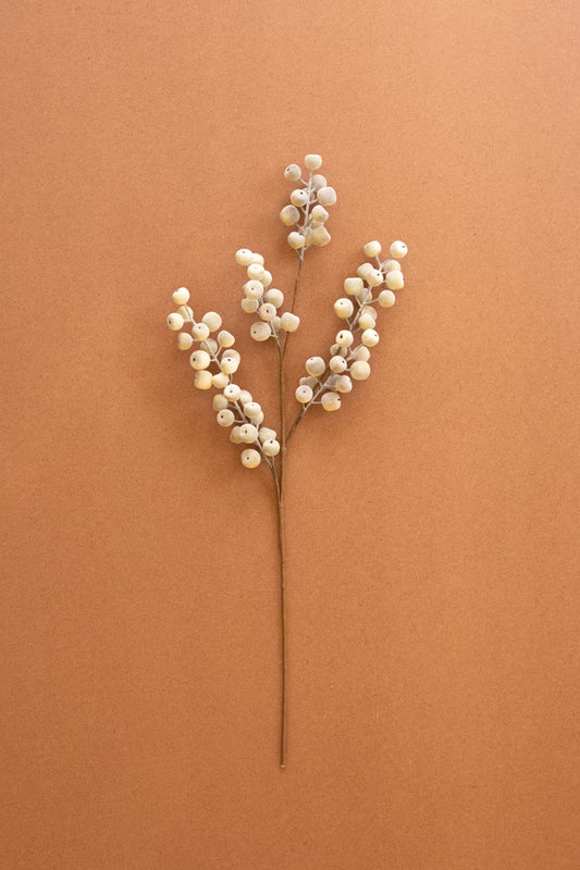 Artificial white berry spray with delicate branching stems and soft white berry clusters.
