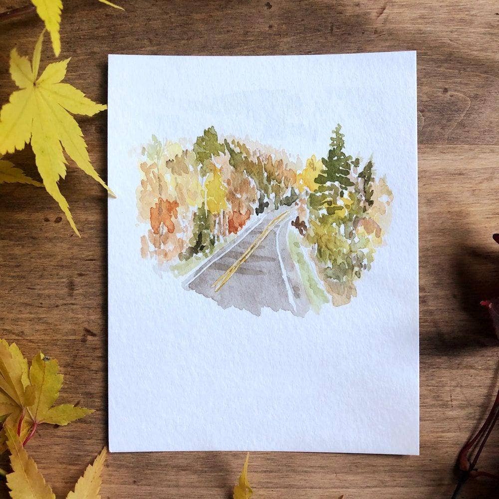 Autumn Road Landscape Watercolor Art Print by Emily Lex featuring an original watercolor painting of a quiet country road surrounded by colorful fall foliage.