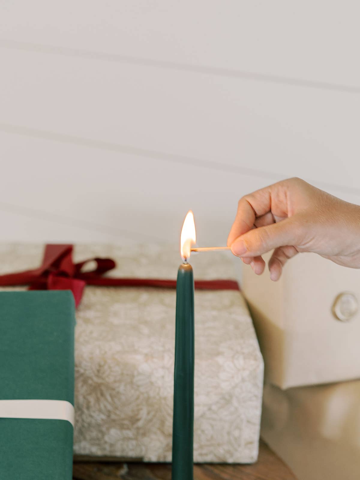 Pair of forest green hand-dipped beeswax taper candles measuring 10 inches tall.