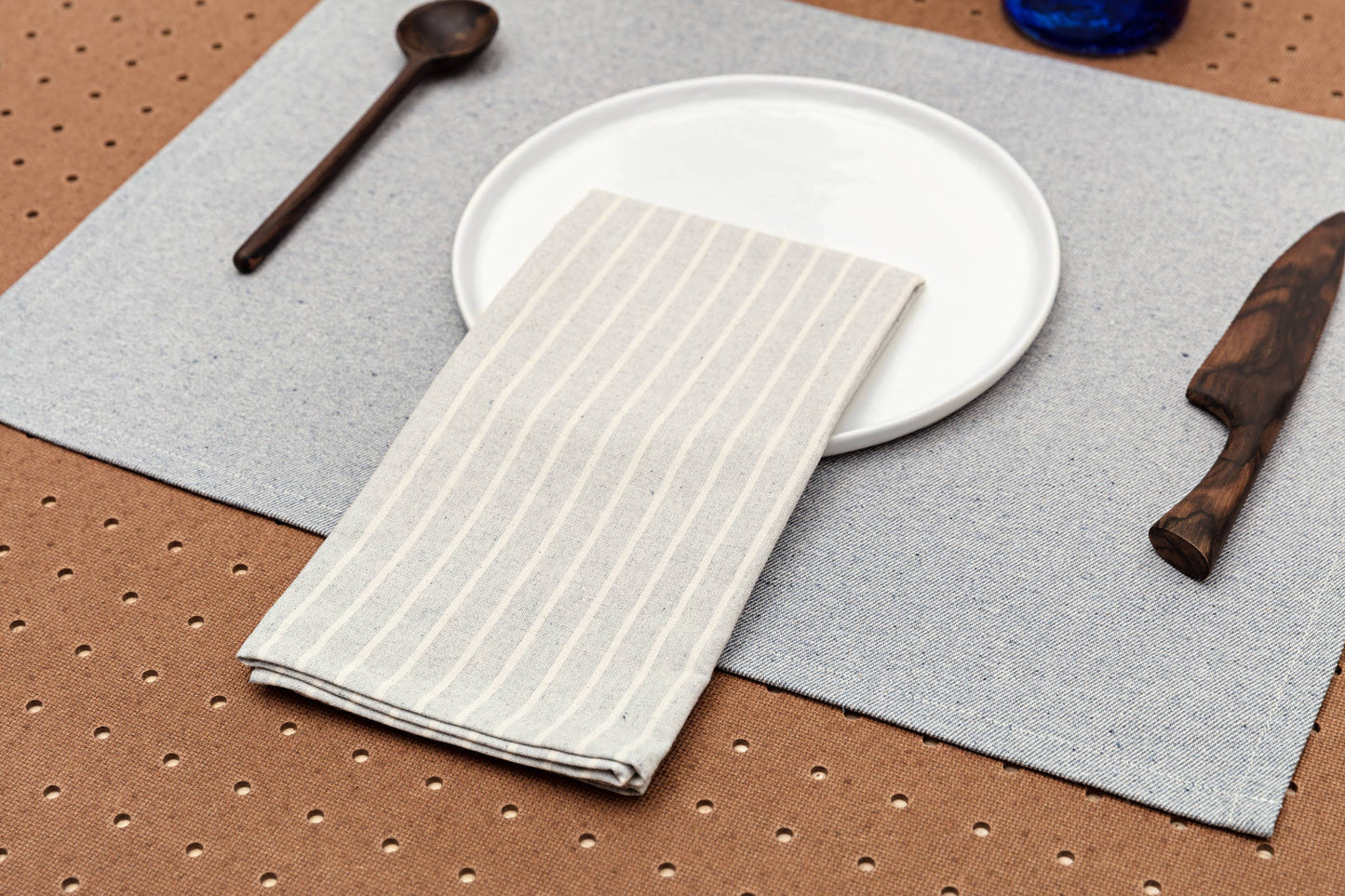 Blue striped napkins styled on a modern farmhouse dining table.
