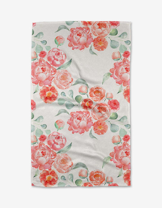 Floral patterned towel with pink and orange flowers on a white background