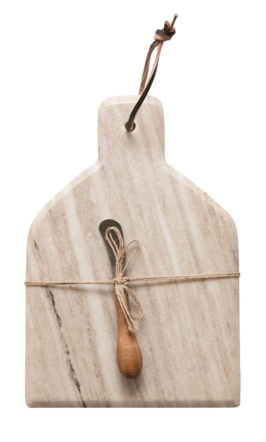 Buff leather cheese board with marble serving surface and coordinating canape knife.