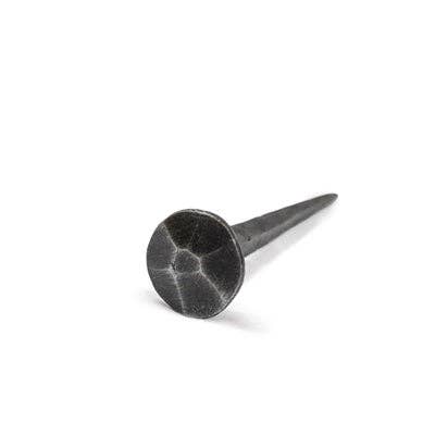 Decorative button head iron nail with a round 1-inch head and 3.5-inch nail length.