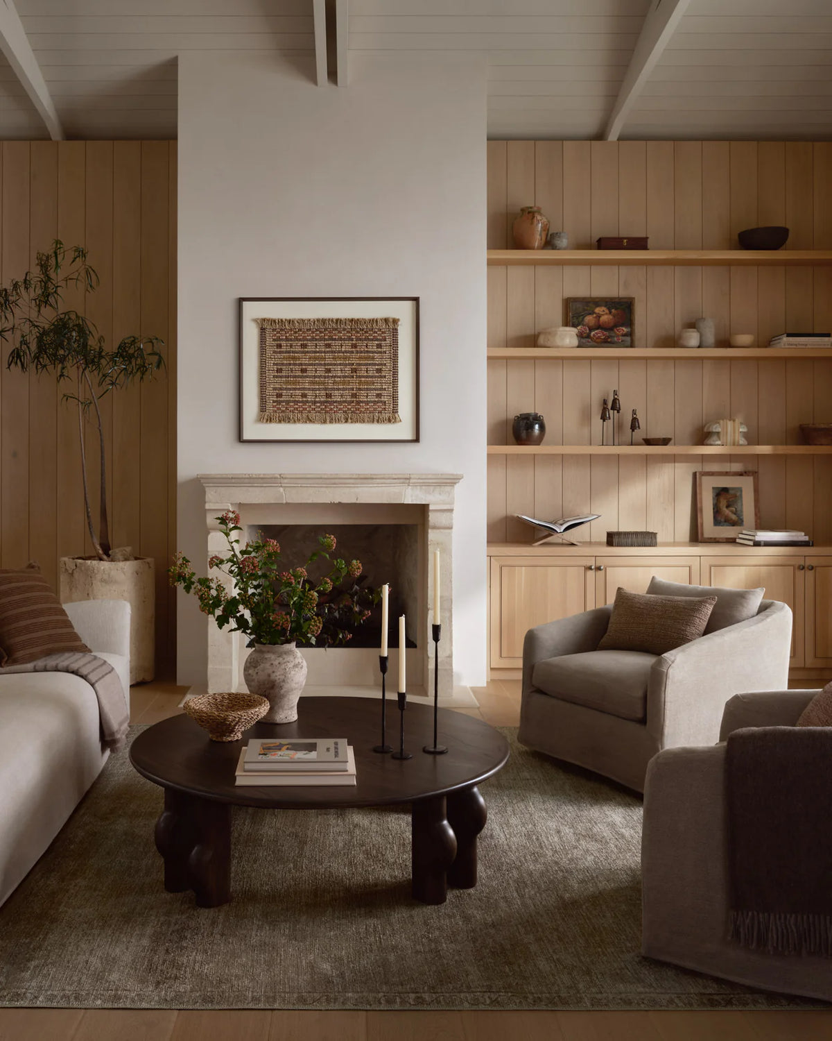 Cambria Ash and Bark area rug styled beneath a linen sofa with oak furniture, layered textiles, and handcrafted ceramics in an organic modern living room.
