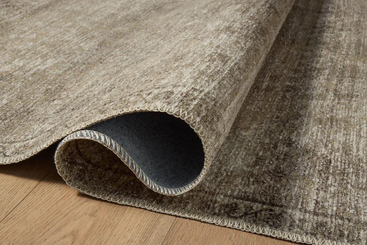 Close-up of the Cambria rug highlighting the weathered vintage motif, woven jute texture, and low-profile construction.
