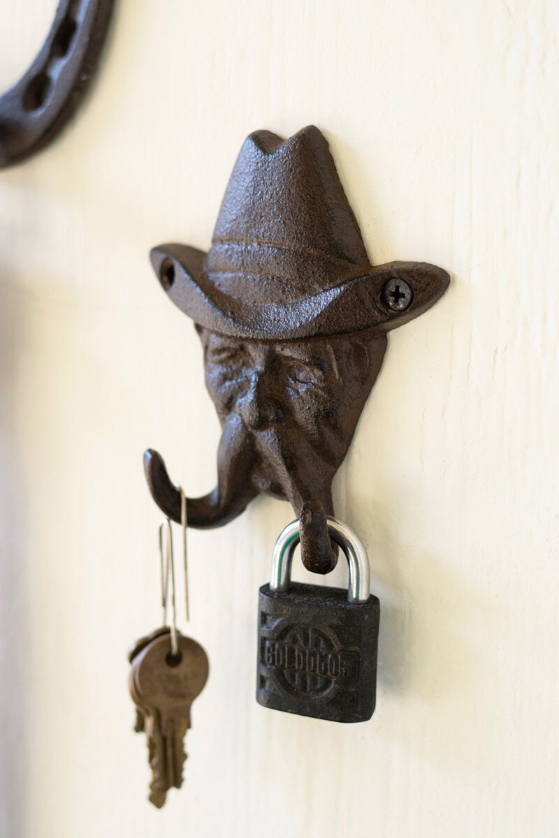 Cast iron cowboy wall hook with a rustic antique finish inspired by the American West.