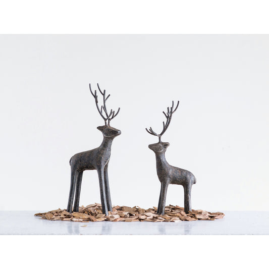 Small and large cast iron standing deer figurines with slender sculptural silhouettes and dark iron finishes.