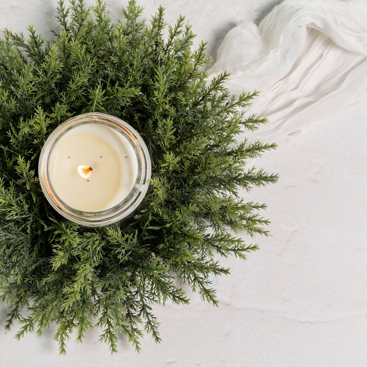 Cedar-inspired greenery candle ring with a full, natural-looking silhouette.
