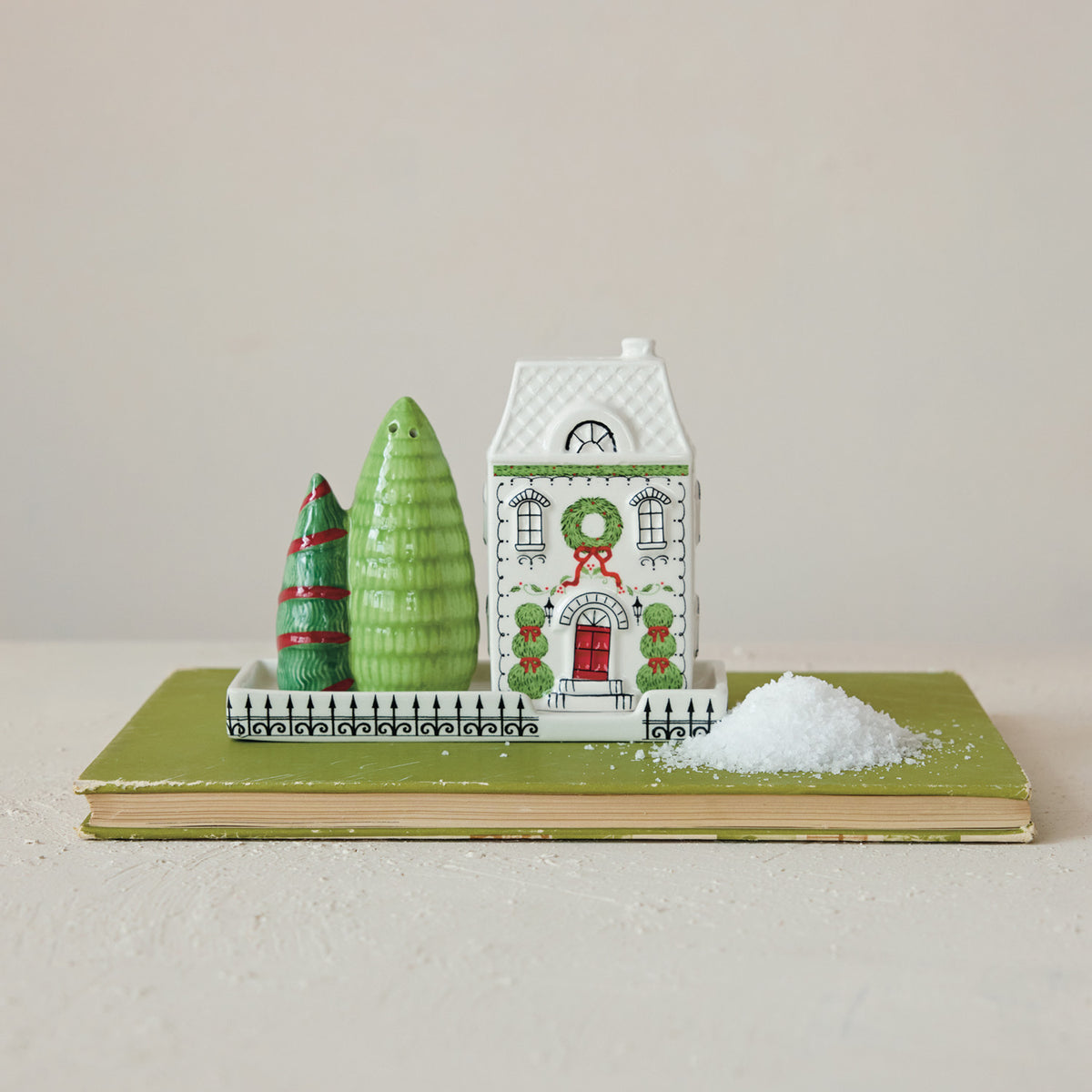 Ceramic Christmas house and trees salt and pepper shaker set with a coordinating tray in white, green, and red.