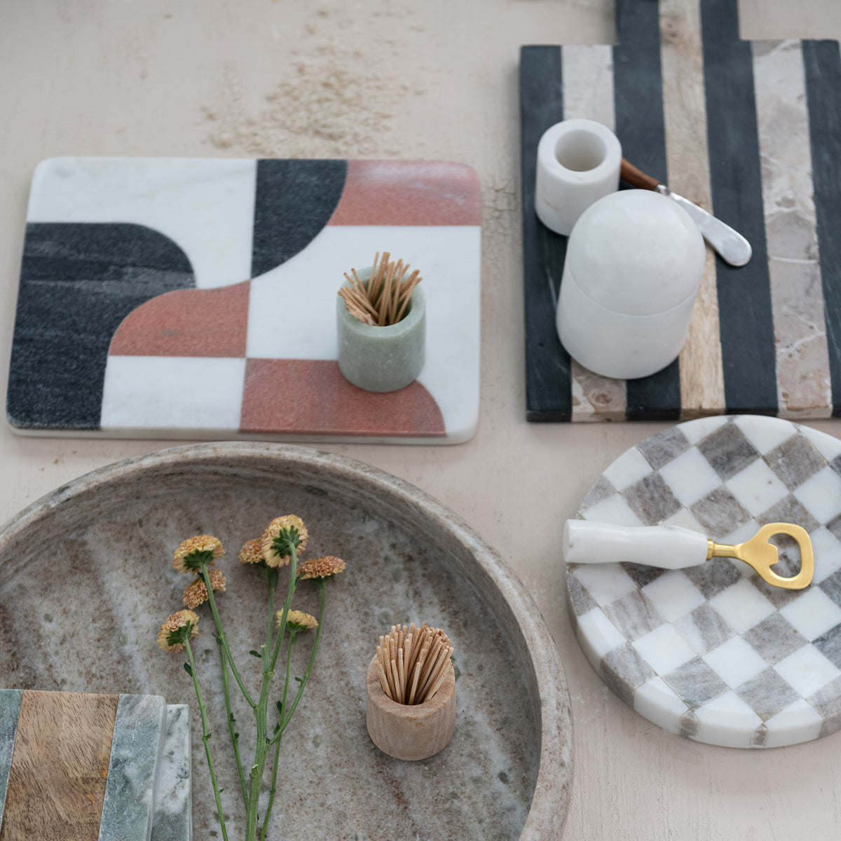 Round buff and white checkered marble serving tray crafted from naturally varied stone.