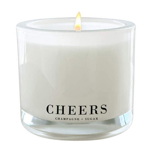 Cheers Champagne + Sugar 9 oz coconut wax candle in a frosted glass jar with clean-burning cotton wick and luxury gift-ready packaging.