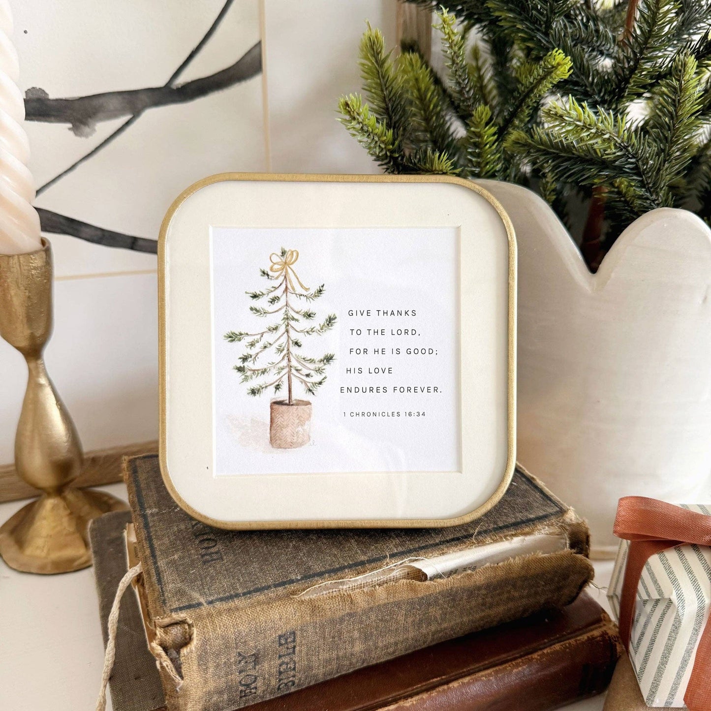 Christmas Gift Truth for Today cards displayed on a wooden card stand alongside evergreen branches, candles, and seasonal décor as part of a Christ-centered Advent display.