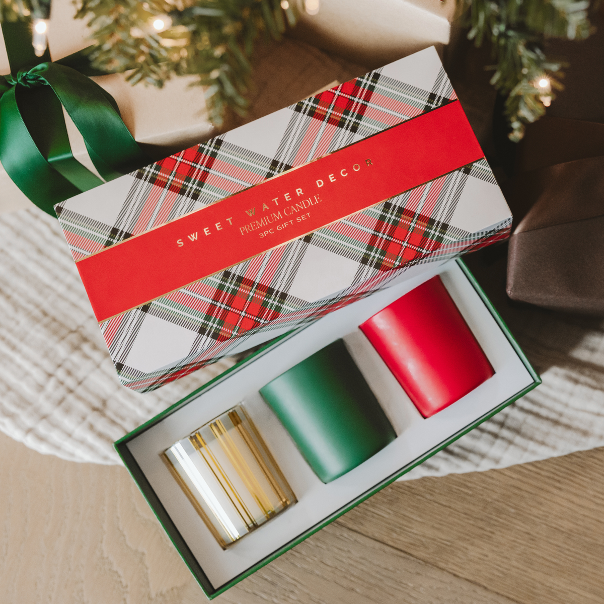 Christmas soy blend candle gift set featuring three 5 oz scented candles in festive red, green, and gold glass vessels.