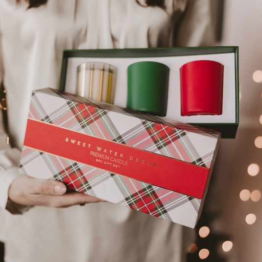 Christmas soy blend candle gift set featuring three 5 oz scented candles in festive red, green, and gold glass vessels.