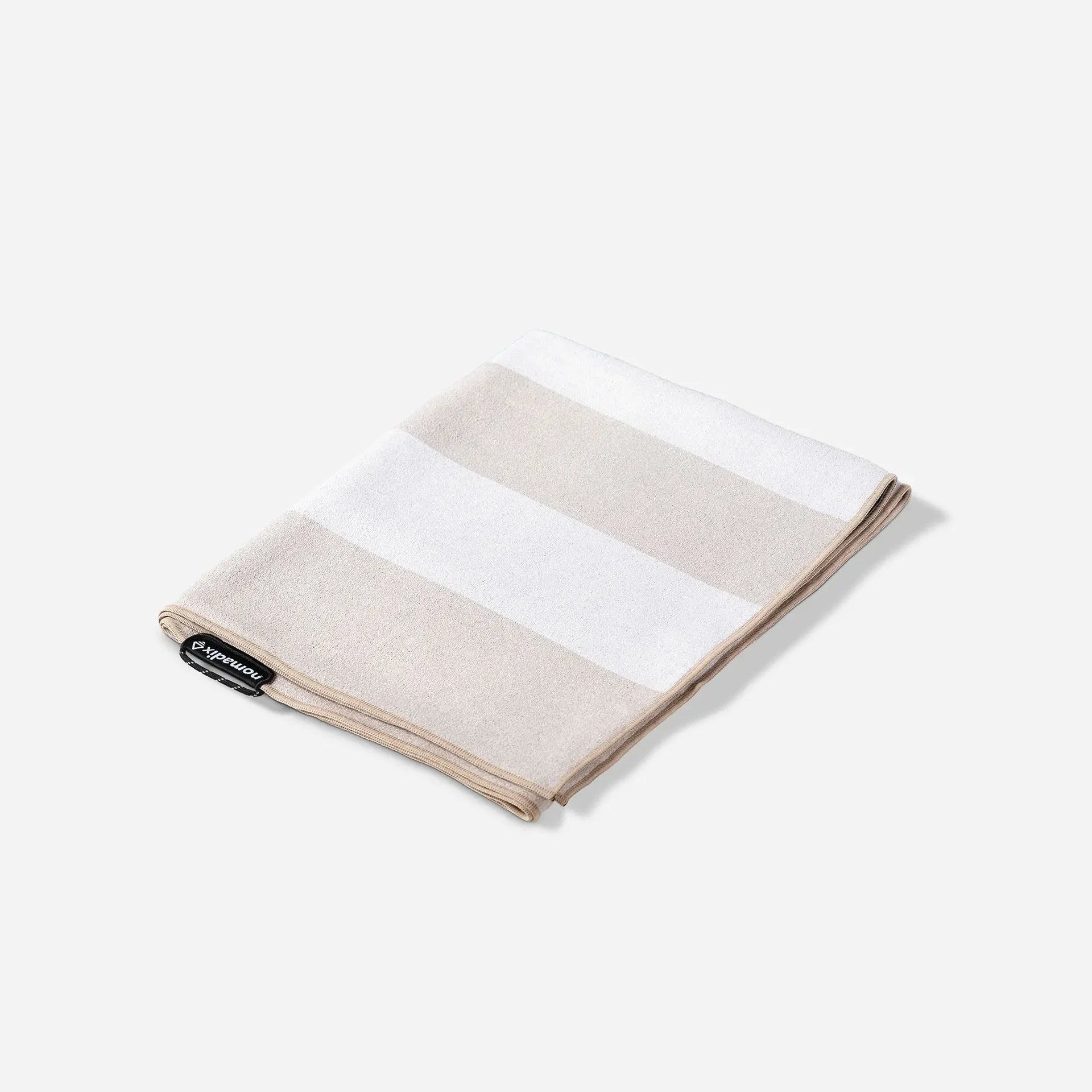 Nomadix Original Travel Towel in Classic Cabana Tan featuring timeless neutral cabana stripes and quick-dry MicroTerry™ performance fabric.
